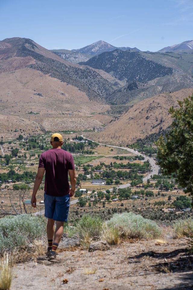 Hiker overlooking Walker, CA and Highway 395 from the hills above